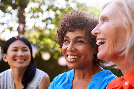 A group of smiling older women with dental implants from Cascade Dental in Medford, OR