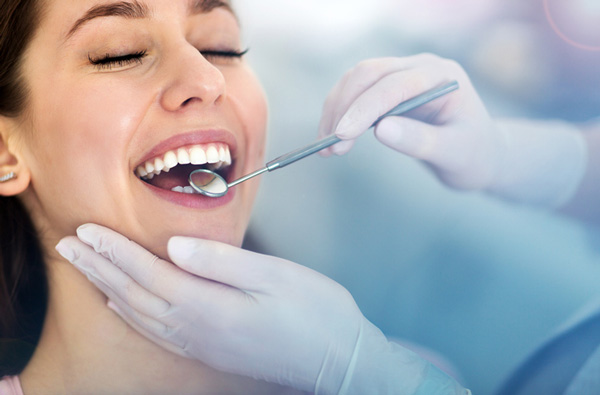 Woman getting dental exam at Cascade Dental in Medford, OR